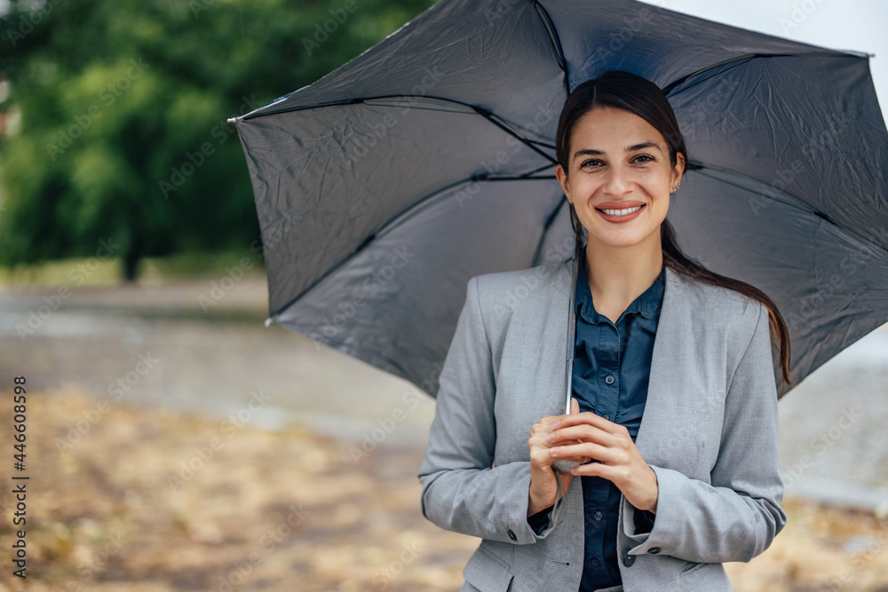 Adult woman protecting herself from the rain.