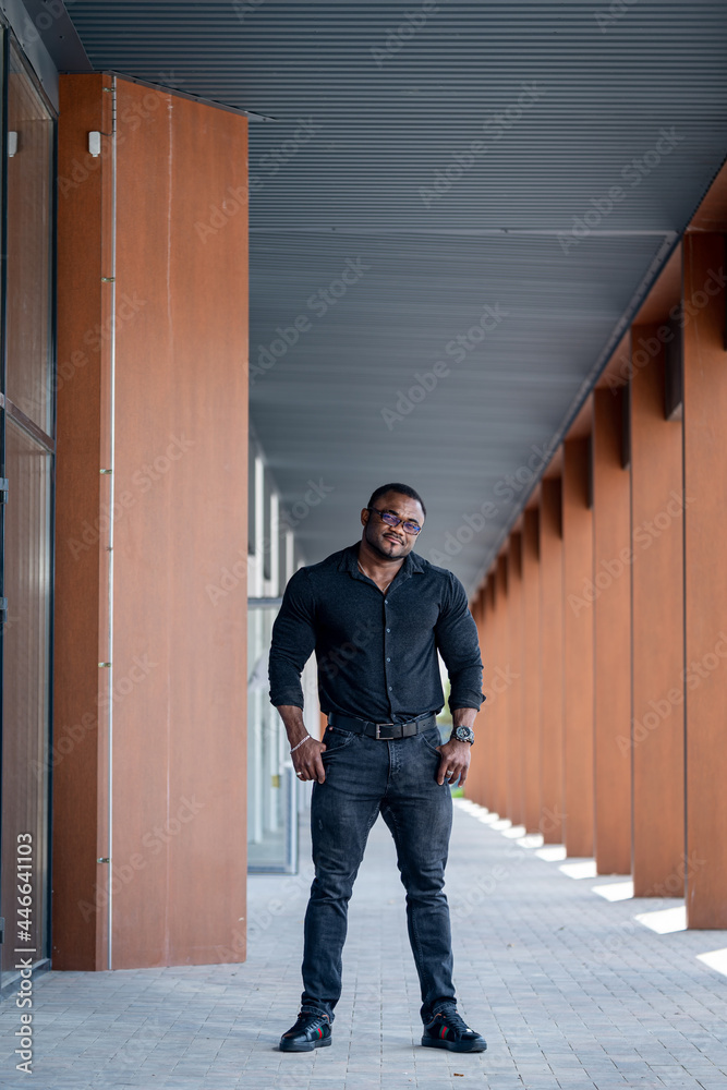 Handsome confident man lifestyle standing on urban street. Fashionable lifestyle young man.