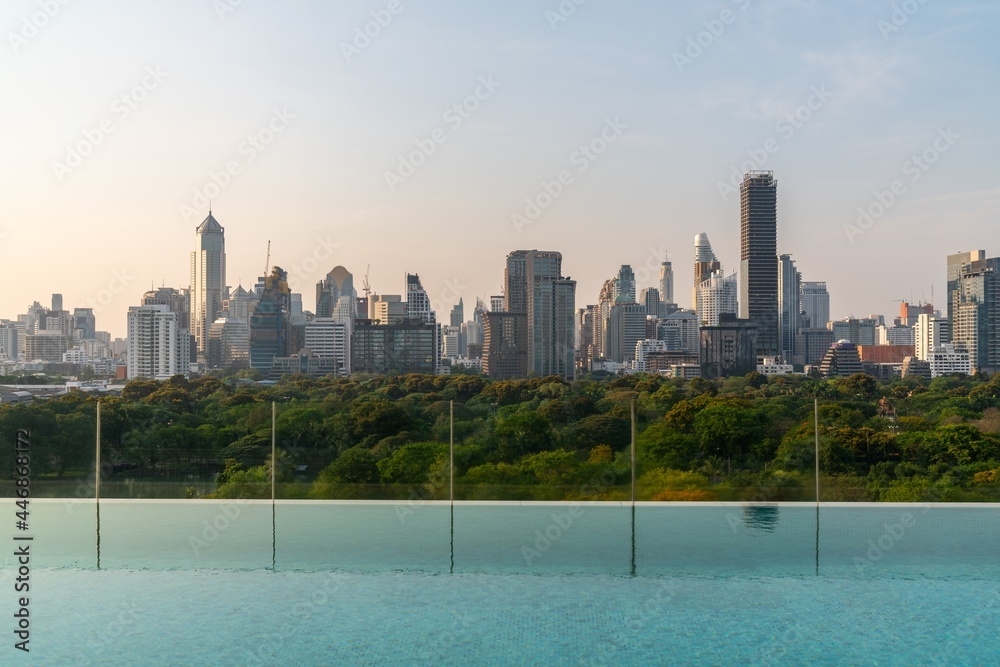 Cityscape and high-rise buildings in metropolis city with water reflection in the early morning .