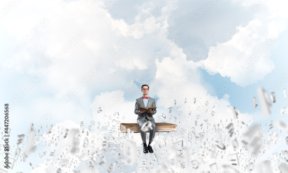 Young businessman or student studying the science and symbols fly around