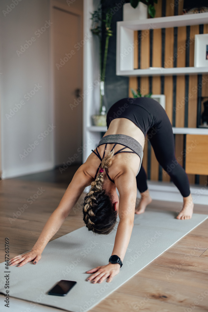 Young woman, working on her flexibility.