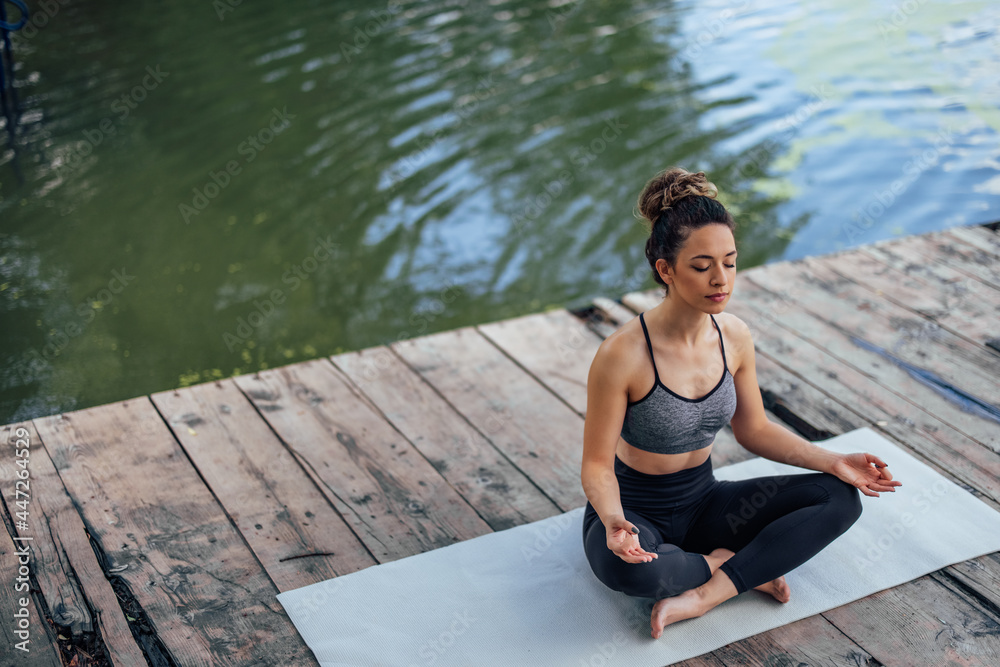 Young woman, doing her training on the deck.