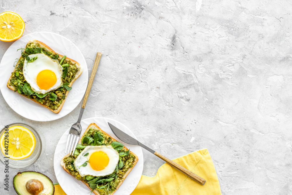 Open sandwich with avocado spinach cream and eggs. Top view