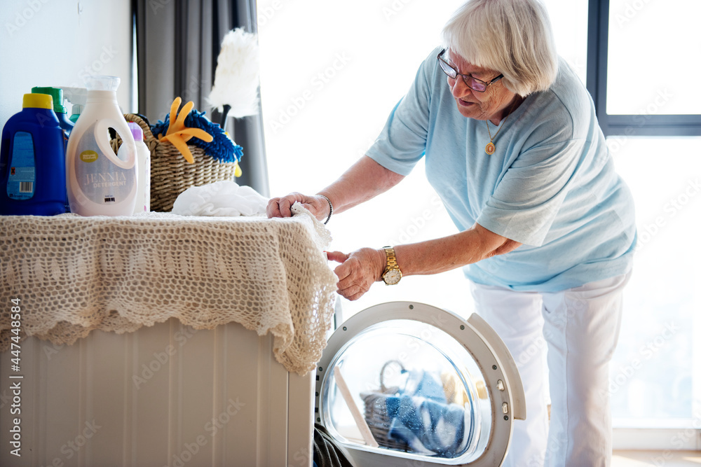 Elderly woman doing laundry