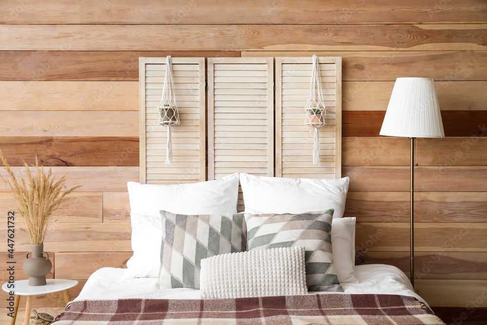 Interior of stylish bedroom with folding screen