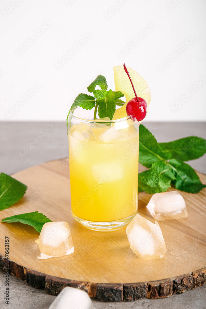 Glass of delicious mai tai cocktail on grey background