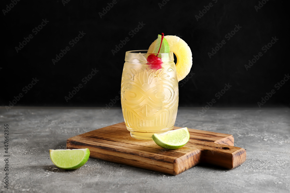 Glass of delicious mai tai cocktail on grey background