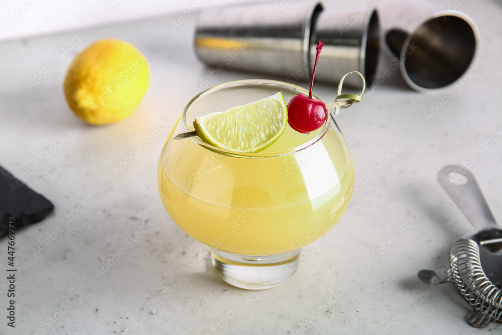 Glass of delicious mai tai cocktail on light background