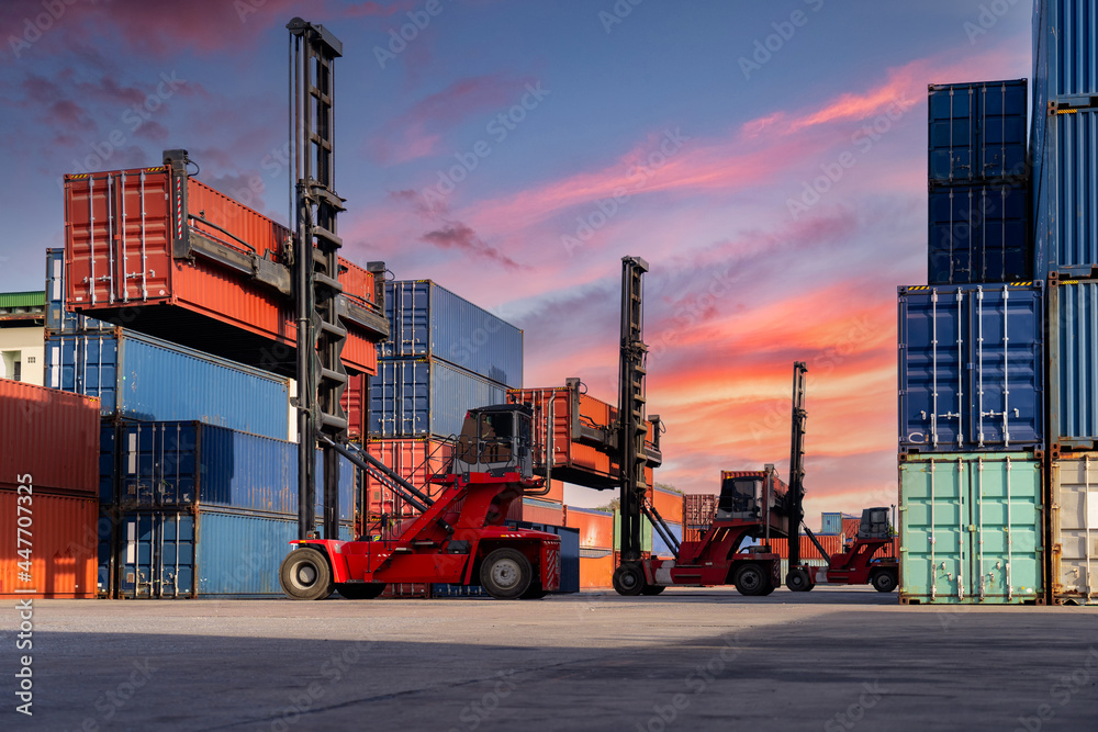 Engineers are overseeing the transportation of cargo with containers inside the warehouse. Container