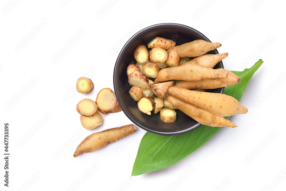 Flat lay of Finger root in black bowl isolated on white background.