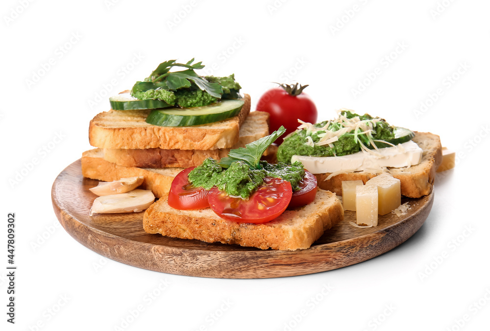 Tasty toasts with pesto sauce on white background