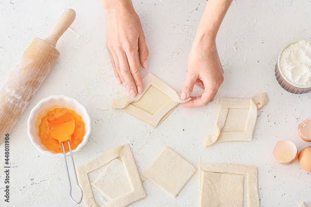 Woman preparing Danish pastry on kitchen table