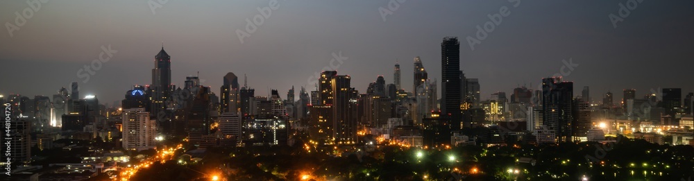 Night cityscape and high-rise buildings in metropolis city center . Downtown business district in pa