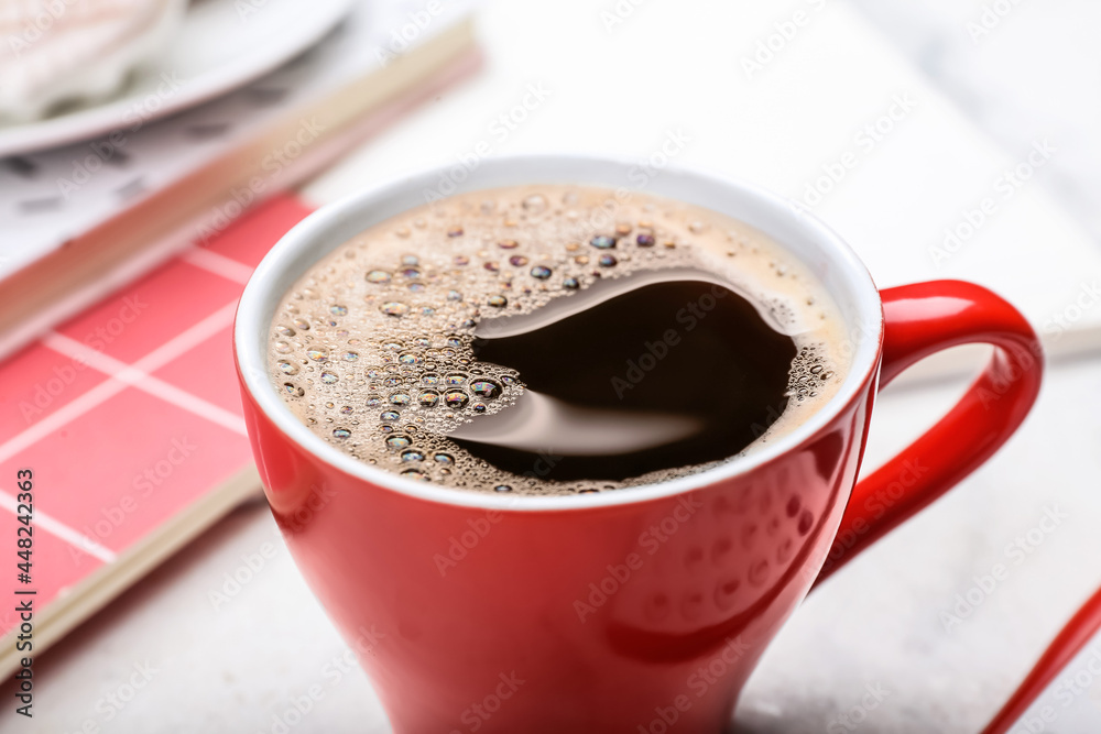 Cup of coffee on light background, closeup