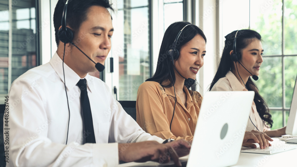 Business people wearing headset working actively in office . Call center, telemarketing, customer su