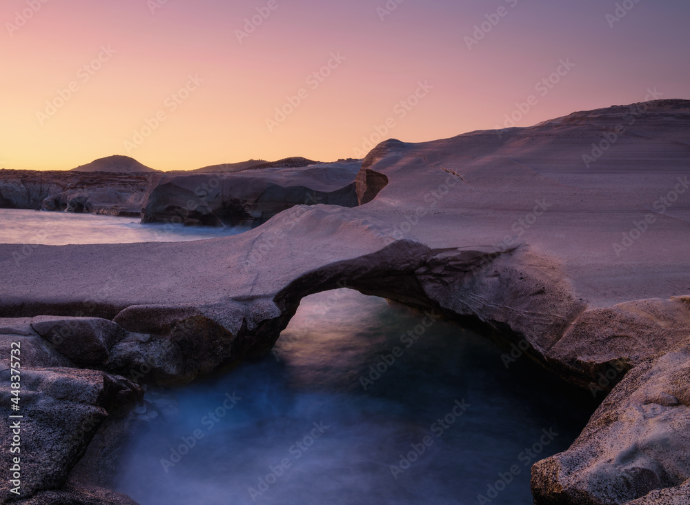 Sarakiniko Beach, Milos Island, Greece. ЫStormy sea and rocks during sunset. A place for rest and re