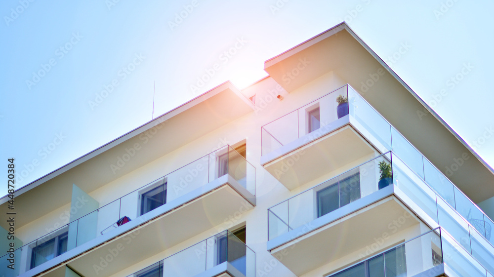 New apartment building with glass balconies. Modern architecture houses by the sea. Large glazing on