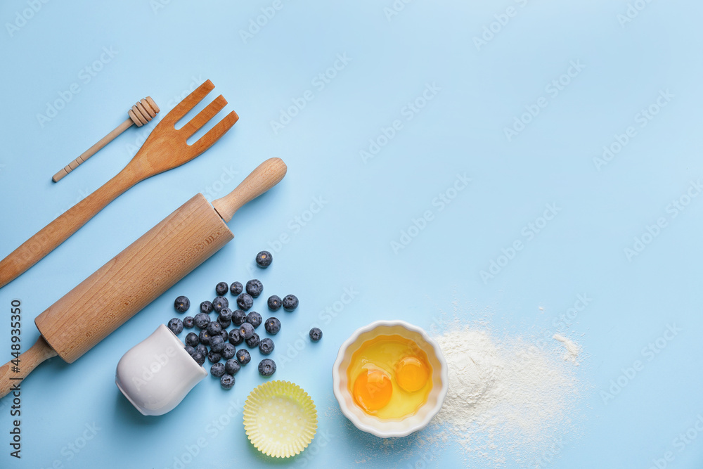 Ingredients for preparing bakery and kitchen utensils on color background