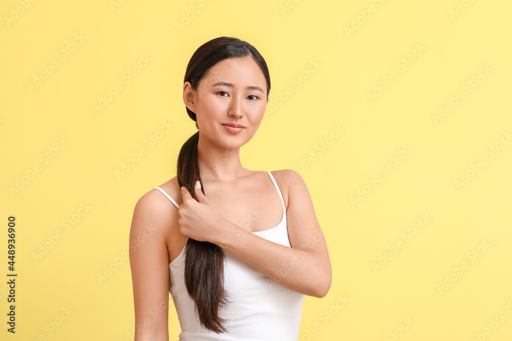 Beautiful young woman on color background