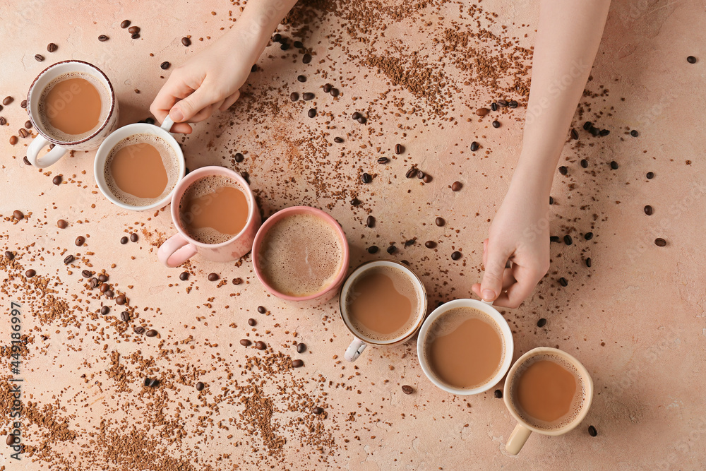 Female hands and cups of coffee on color background