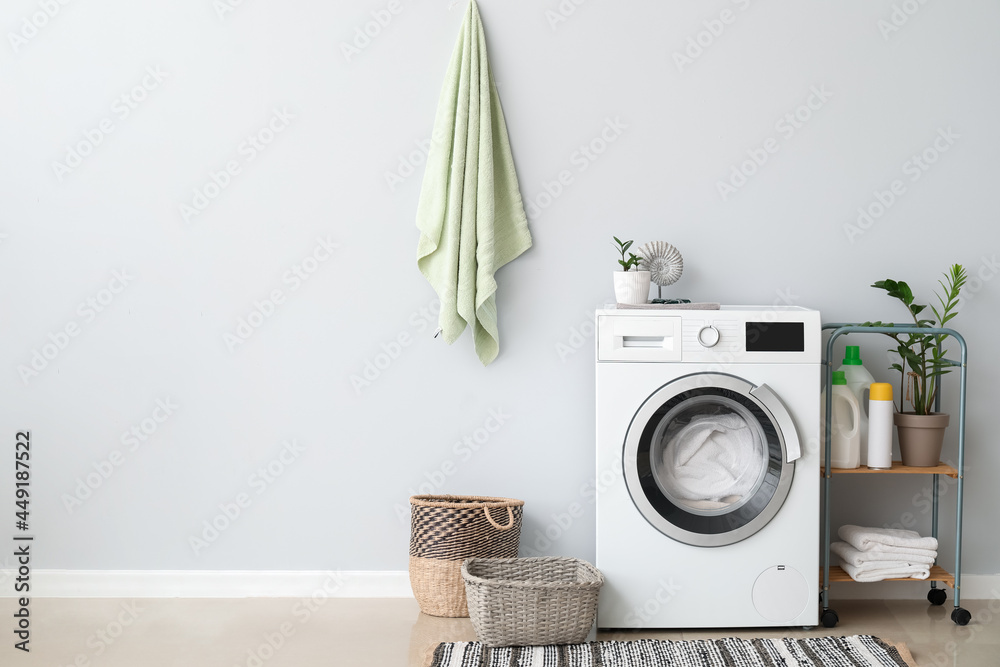 Interior of bathroom with modern washing machine