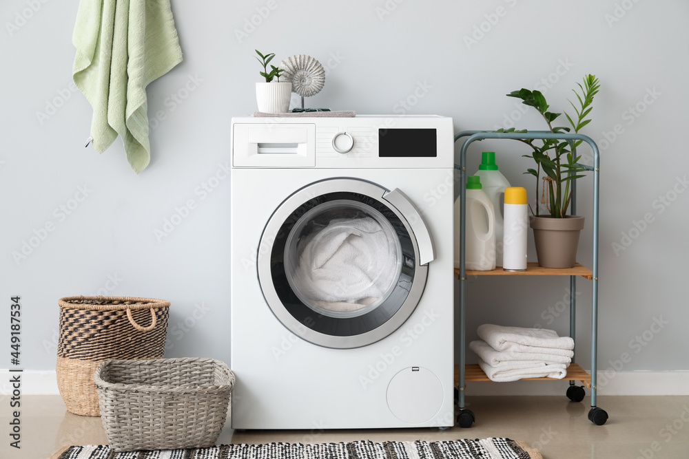 Interior of bathroom with modern washing machine