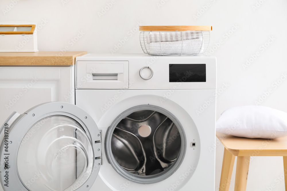 Modern washing machine in kitchen