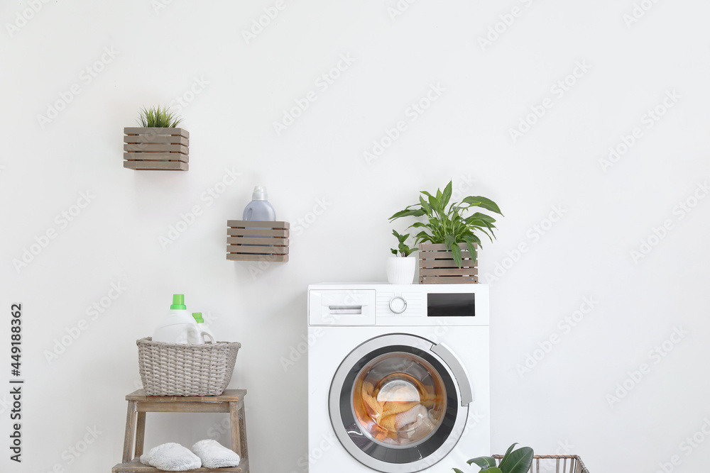 Interior of bathroom with modern washing machine