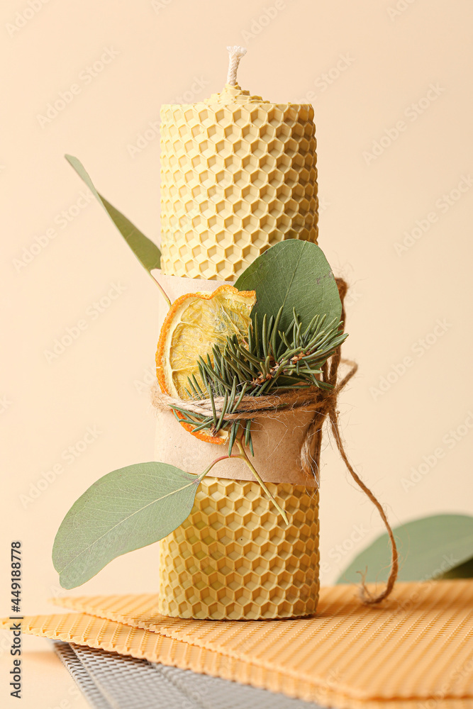 Handmade wax candle on color background