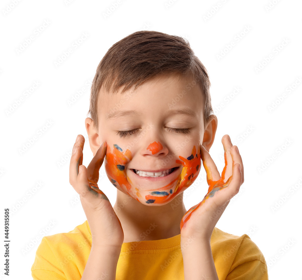 Cute little boy with paint on face against white background