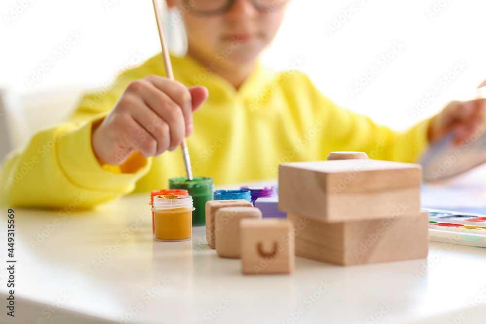 Cute little boy painting at home