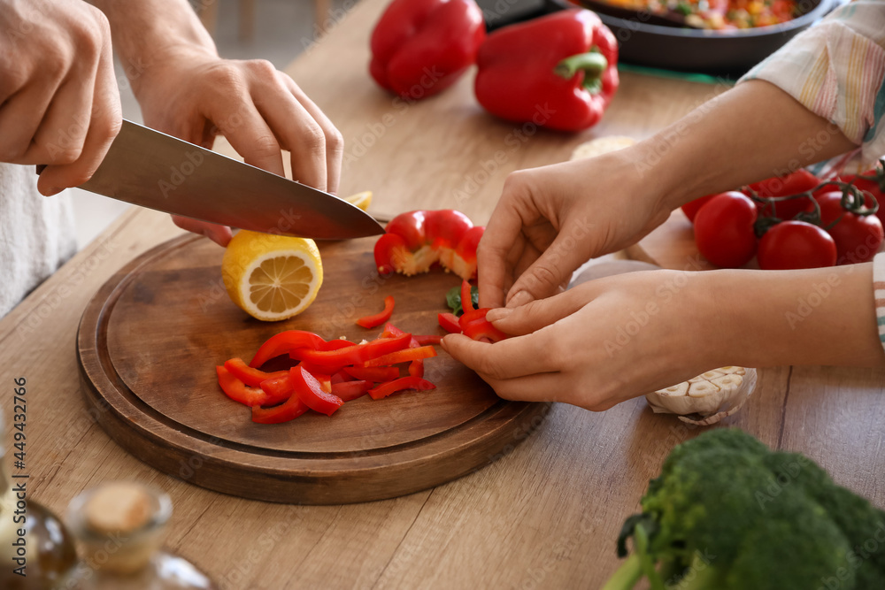 Young couple cooking in kitchen, closeup