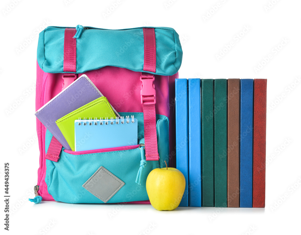 School backpack, books and apple on white background