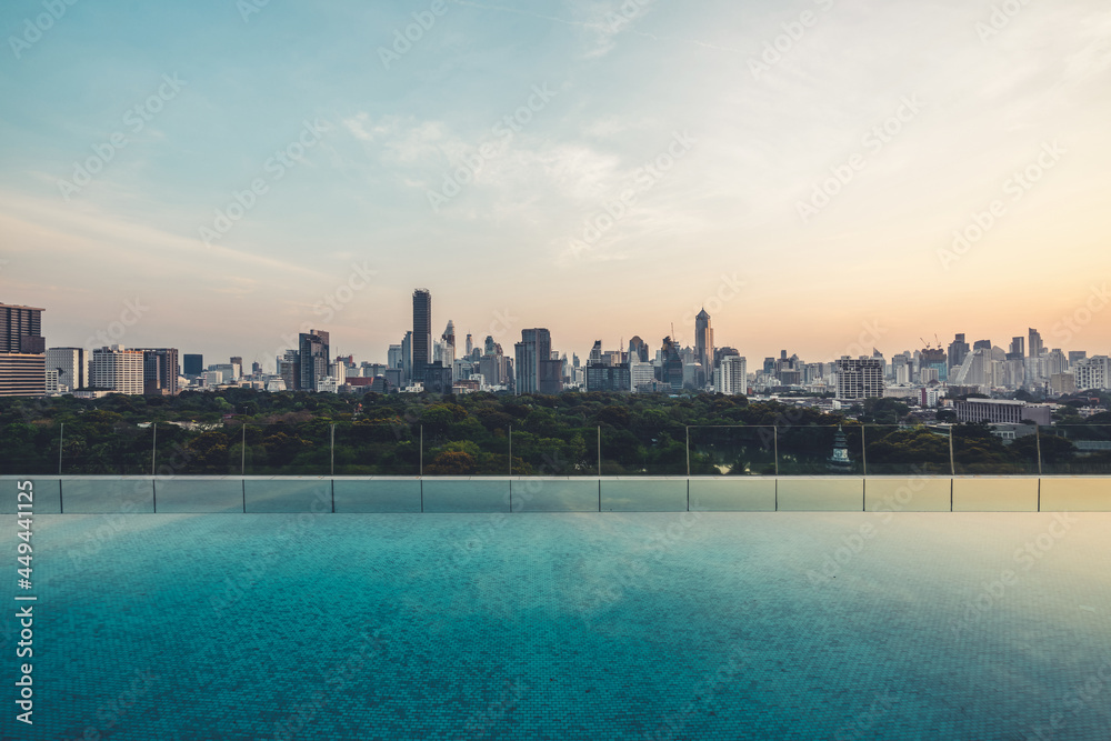 Cityscape and high-rise buildings in metropolis city with water reflection in the early morning .