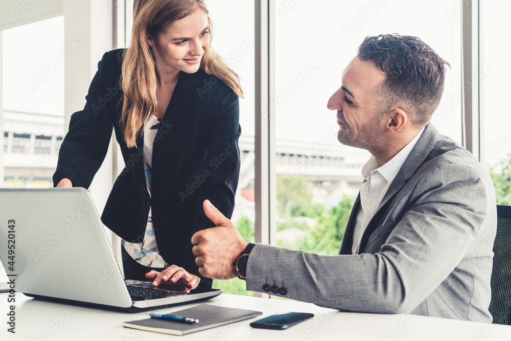 Businessman executive is in meeting discussion with a businesswoman worker in modern workplace offic