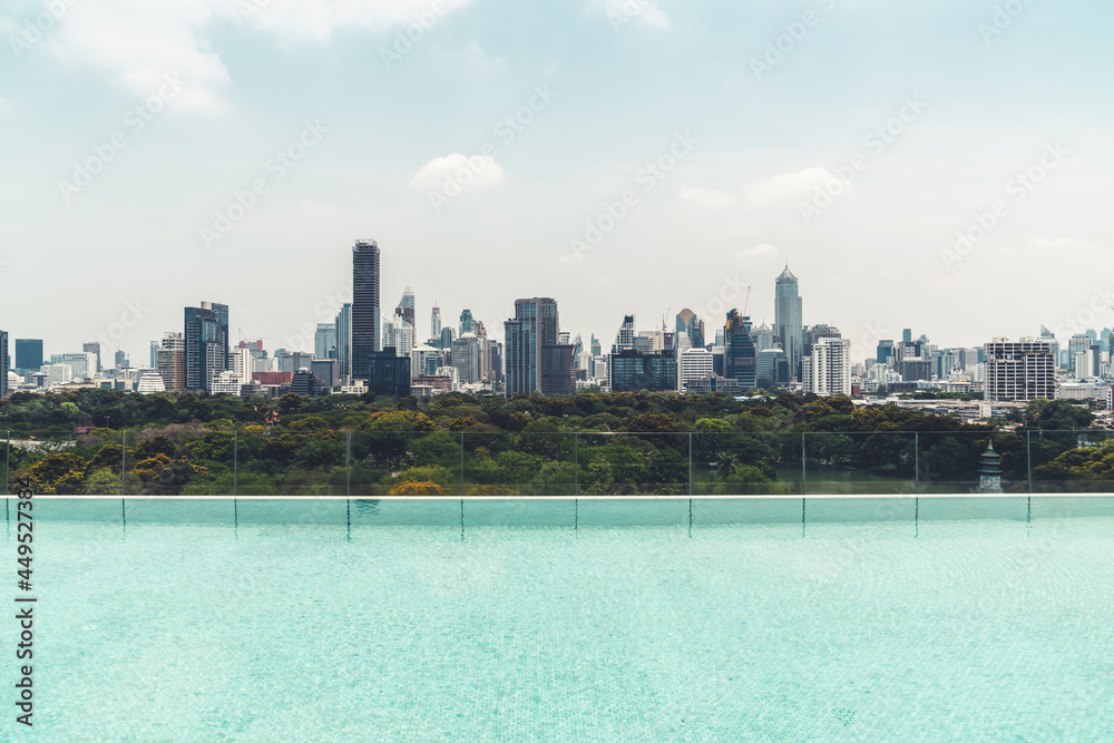 Cityscape and high-rise buildings in metropolis city with water reflection in the early morning .