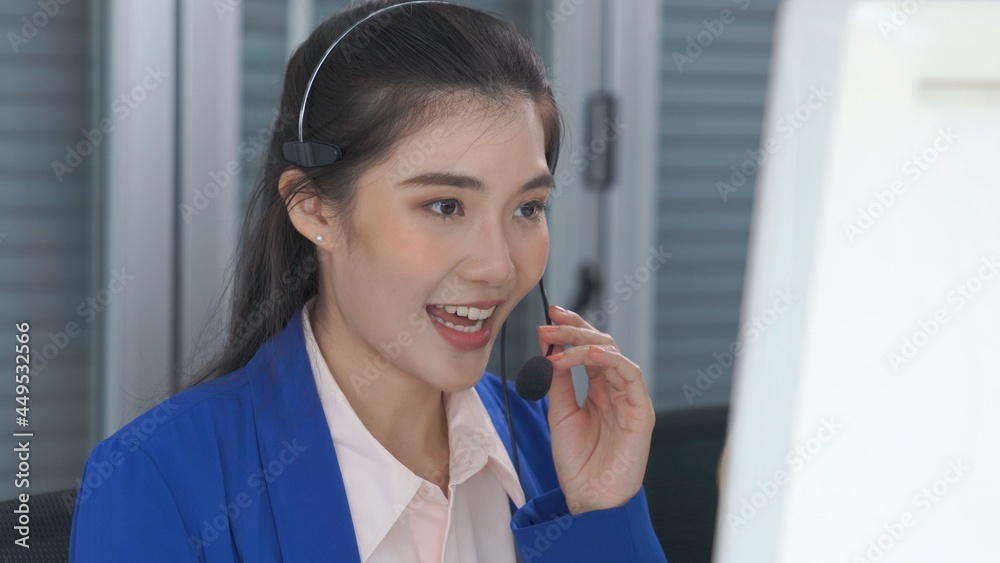 Businesswoman wearing headset working actively in office . Call center, telemarketing, customer supp