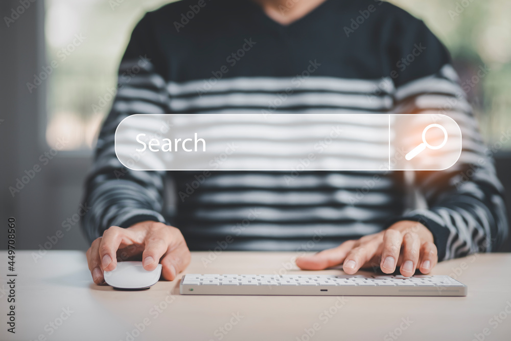 Searching Browsing Internet Data Information with blank search bar. mans hands are using a computer