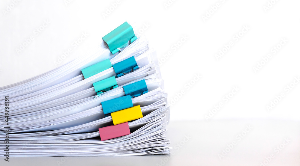 Stack of documents placed on a business desk in a business office.