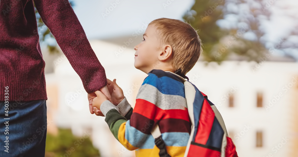 Mother and her son walking to the school