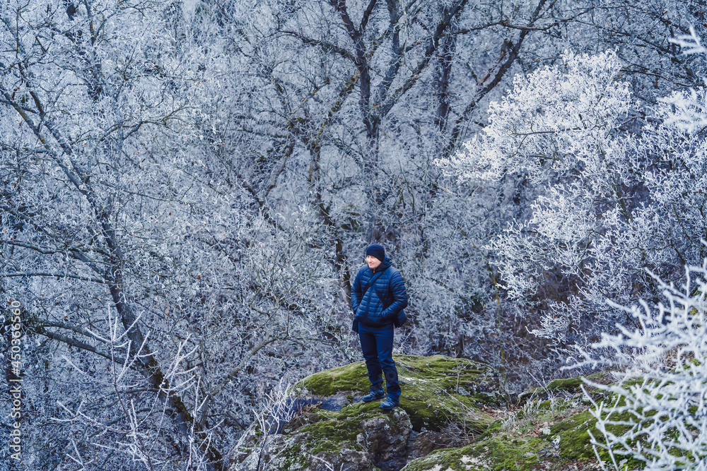 Serious man preparing to taking photos on professional camera of picturesque landscape. Male looking