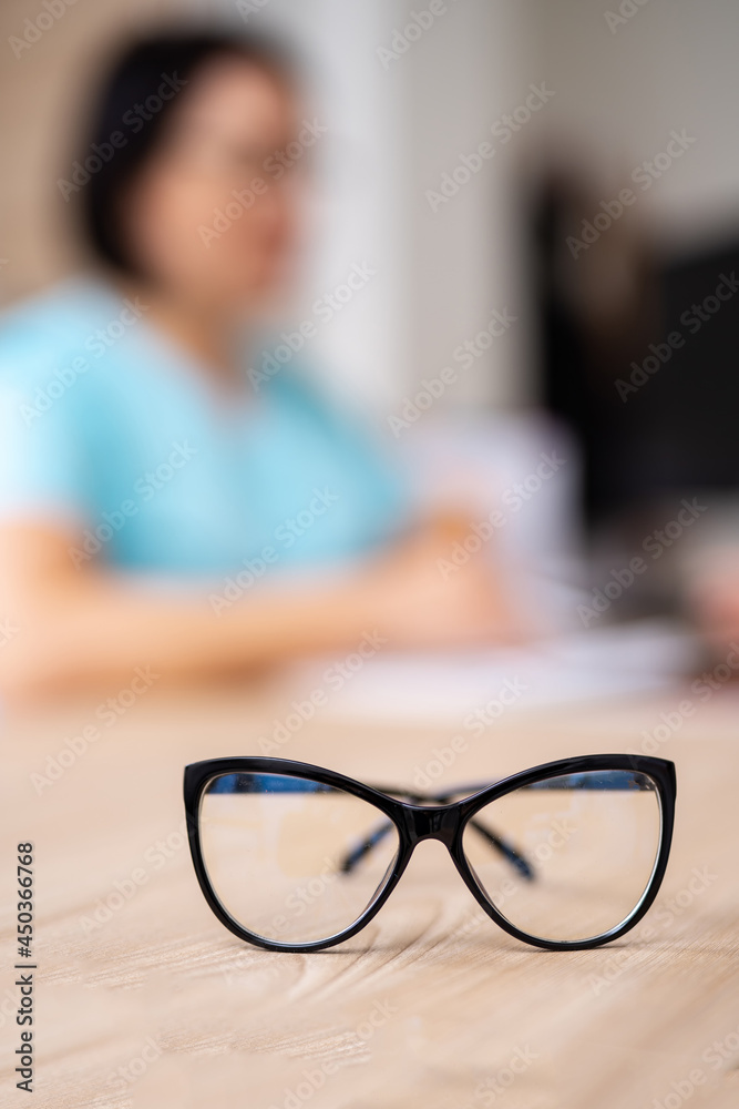 Close up eyeglasses staying at the table. Medical ophthalmology professional eyeglasses. Medicine co