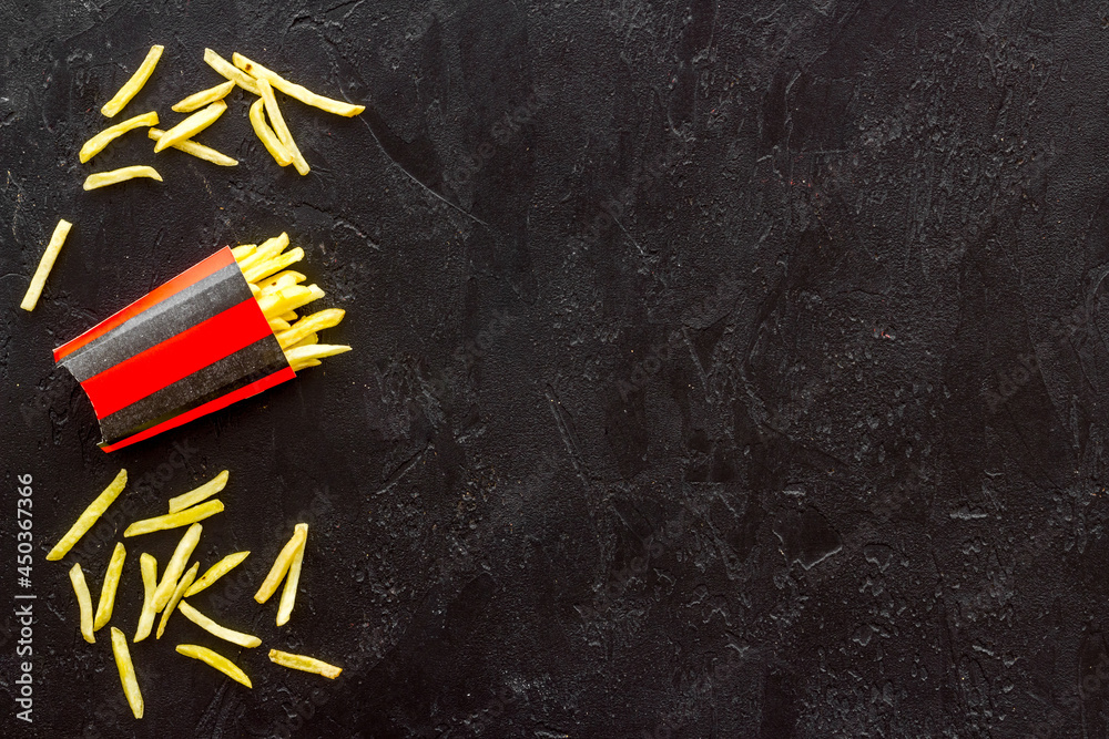 Potatoes french fries in paper box, top view