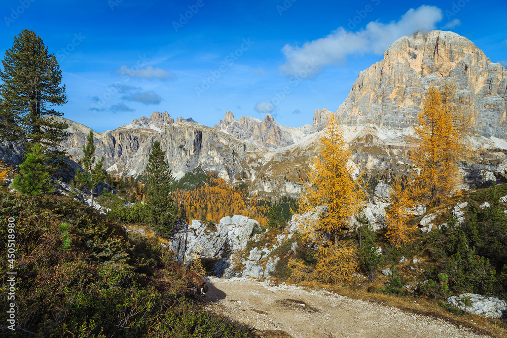 Alpine place and autumn scenery with colorful larches, Dolomites, Italy