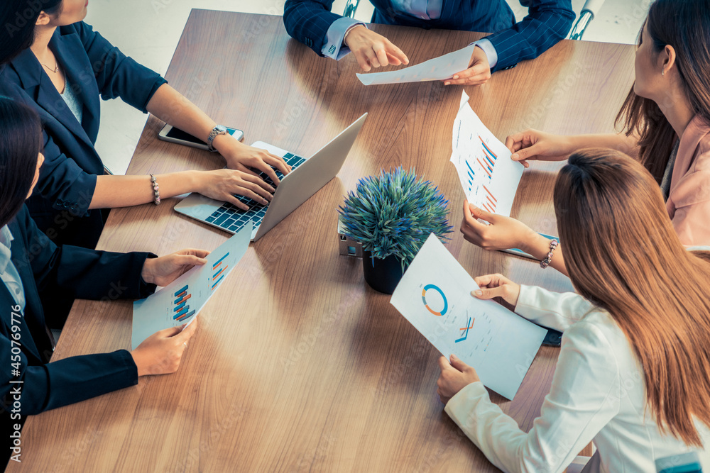 Businesswoman in group meeting discussion with other businesswomen colleagues in modern workplace of