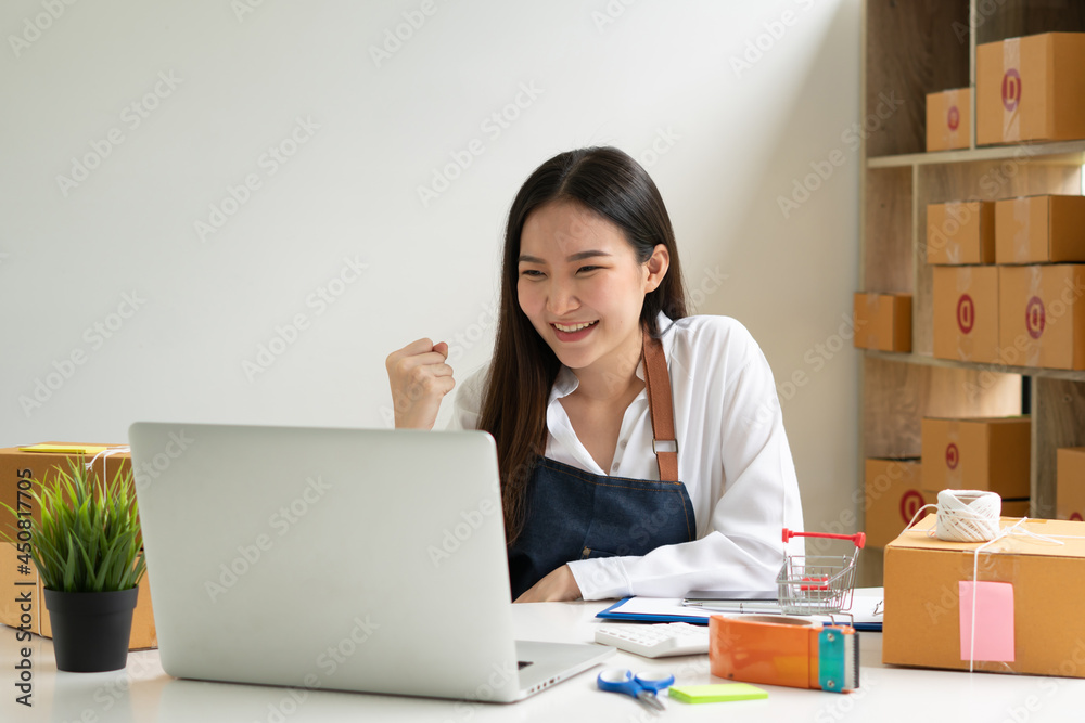 Startup small business entrepreneur SME, young asian woman working with laptop computer and delivery