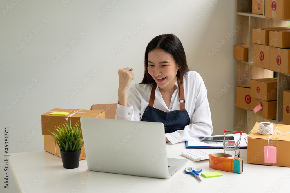 Startup small business entrepreneur SME, young asian woman working with laptop computer and delivery