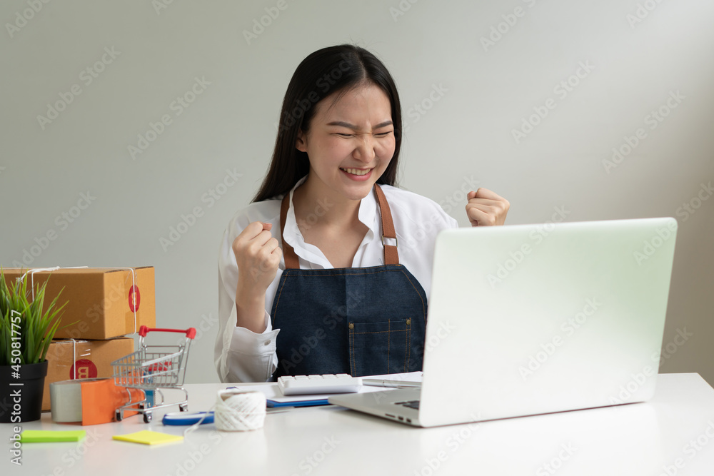 Startup small business entrepreneur SME, young asian woman working with laptop computer and delivery