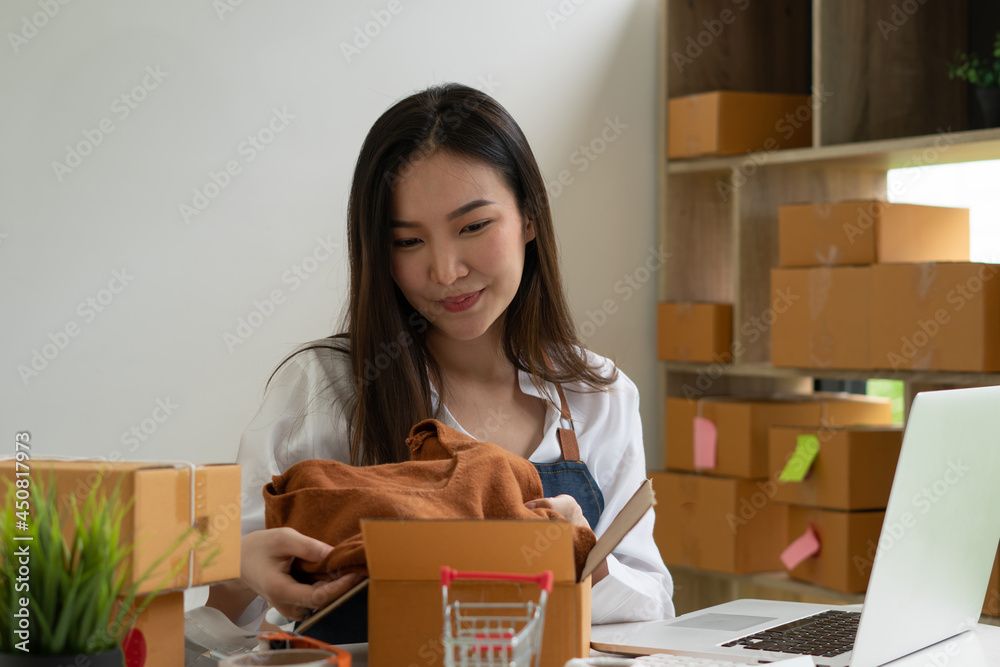 Startup small business entrepreneur SME, young asian woman working with laptop computer and delivery