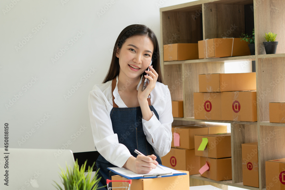 Startup small business entrepreneur SME, young asian woman working with laptop computer and delivery